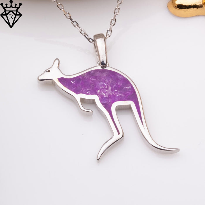 Close-up product photograph of a purple amethyst kangaroo pendant on a silver-colored chain against a white surface