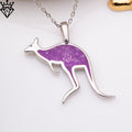 Close-up product photograph of a purple amethyst kangaroo pendant on a silver-colored chain against a white surface
