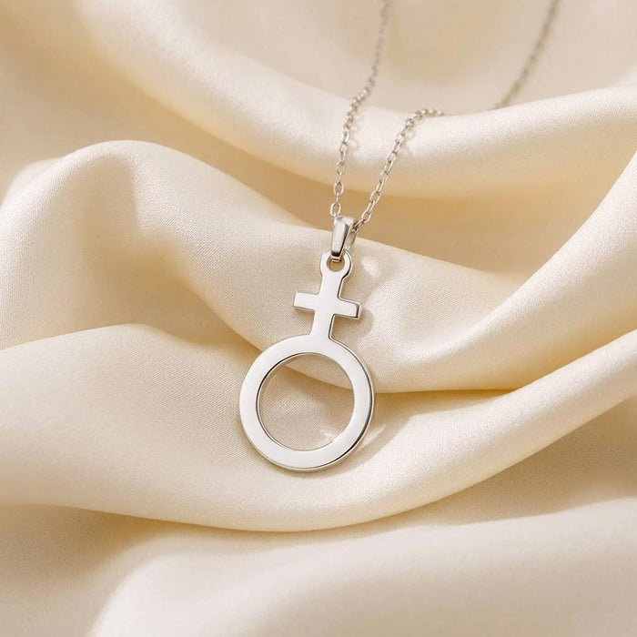 Silver Antimony cross-and-open-circle pendant on ivory satin