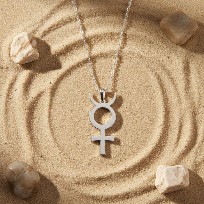 Silver Antimony Symbol Necklace with curved upper tips displayed on patterned sand