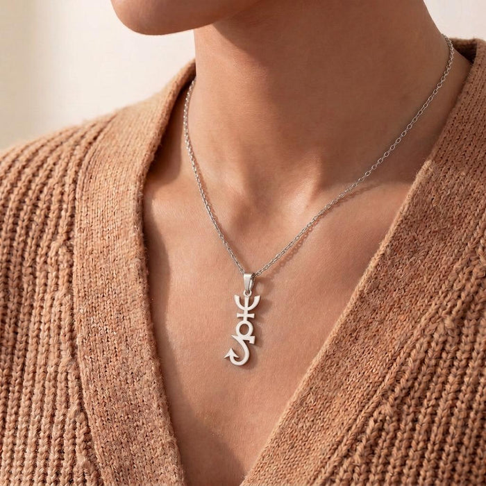 Apophis Symbol Necklace worn over a tan textured knit cardigan