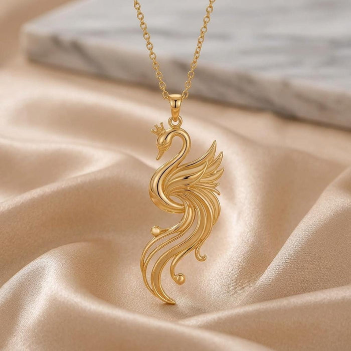 Front view of the Gold Plated Silver Aurora Swan Pendant with layered openwork wing feathers on champagne satin
