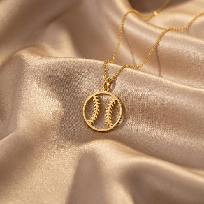 Gold Plated Silver Baseball Necklace with open circular seam pendant arranged on champagne satin