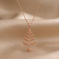 Rose Gold Plated Cedar Crest Necklace with tiered branch pendant on beige satin
