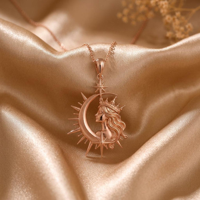 Rose Gold Plated Cosmic Queen Necklace with crowned profile, crescent frame, stars, and radiant rays on champagne satin