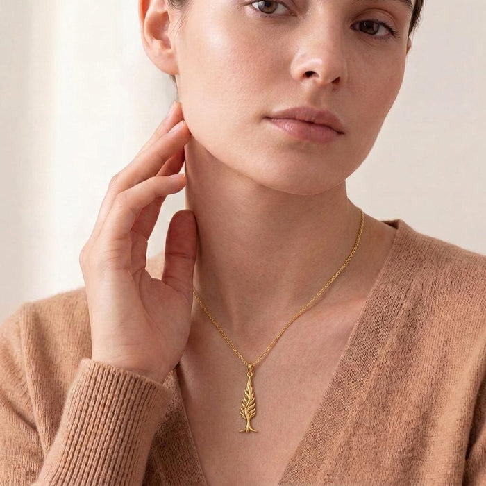 Gold Plated Silver Cypress Flame Pendant worn on a model with a neutral knit top