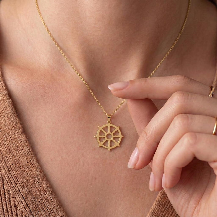 Close view of the Gold Plated Silver Dharma Wheel pendant at the collarbone