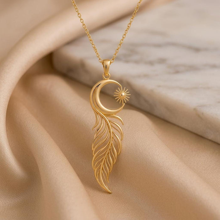 Close-up of the Eclipse Feather Necklace on champagne fabric beside a pale stone surface