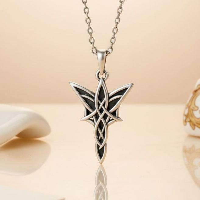 Elven star pendant necklace displayed upright on a reflective neutral surface