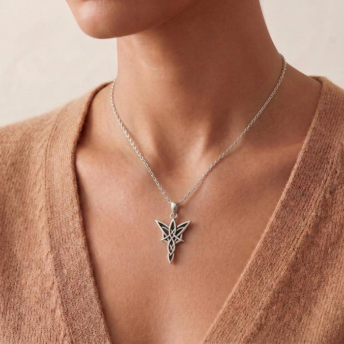 Close neckline view of a model wearing the Handmade Elven Star Necklace with an open knit top