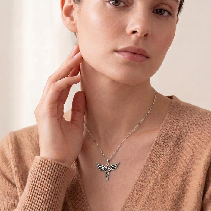 Elven Wing Necklace centered at the neckline of a model wearing a V-neck brown knit top