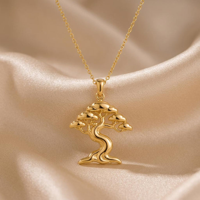 Gold Plated Silver Ficus Flow Necklace with a flowing tree pendant on champagne satin