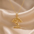 Gold Plated Silver Ficus Flow Necklace with a flowing tree pendant on champagne satin