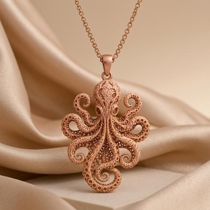Rose Gold Plated Fossil Octopus Pendant necklace with curled openwork tentacles on champagne satin and a stone pedestal