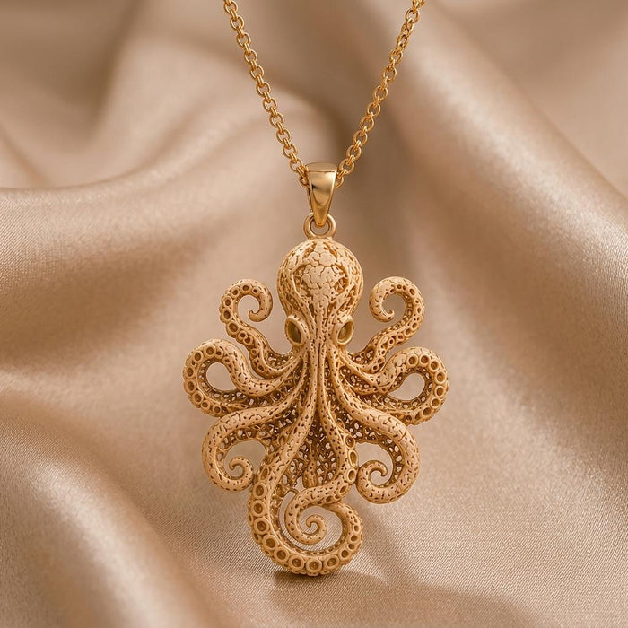 Gold Plated Silver Fossil Octopus Pendant close-up with textured head and curled tentacles on champagne satin