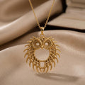 Gold Plated Silver Fossil Owl Halo pendant necklace with circular eye openings and feather-like openwork on beige satin
