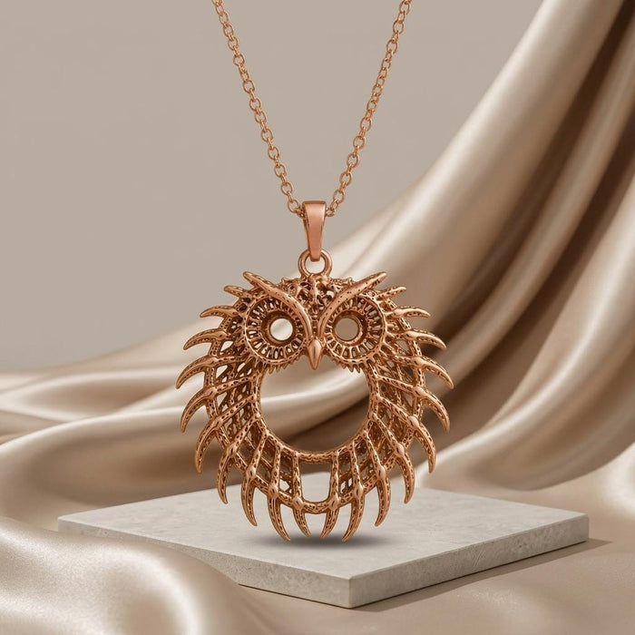 Rose Gold Plated Fossil Owl Halo pendant necklace above a pale stone platform with satin backdrop