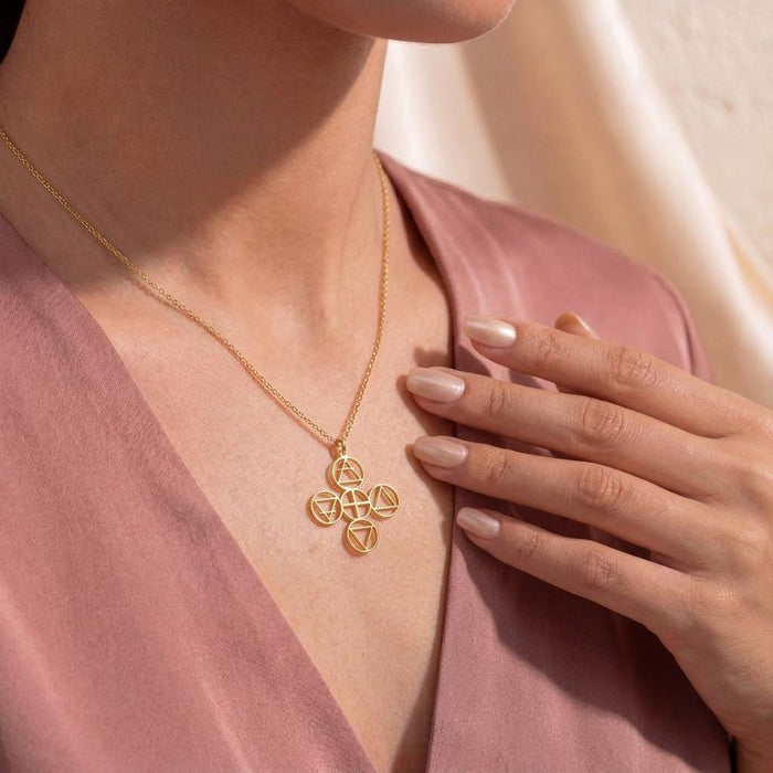 Gold Plated Silver Four Elements Necklace worn with a pink V-neck blouse