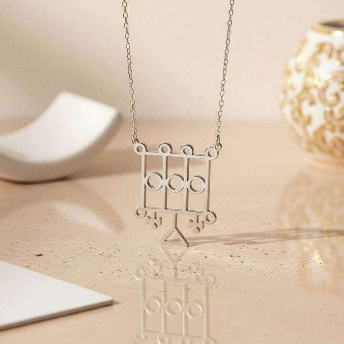 Silver Furcas Sigil Necklace displayed upright on a reflective neutral surface