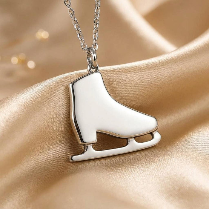 Close-up of the polished ice skate pendant showing the closed boot silhouette and defined blade