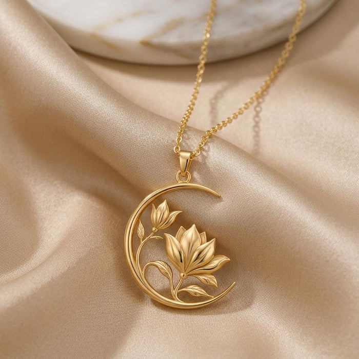 Gold Plated Silver Lunar Magnolia Pendant with layered magnolia flowers inside an open crescent frame on champagne satin