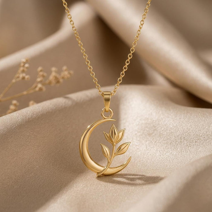 Gold Plated Silver Lunar Petal Pendant with an open crescent and three-leaf sprig on folded champagne satin