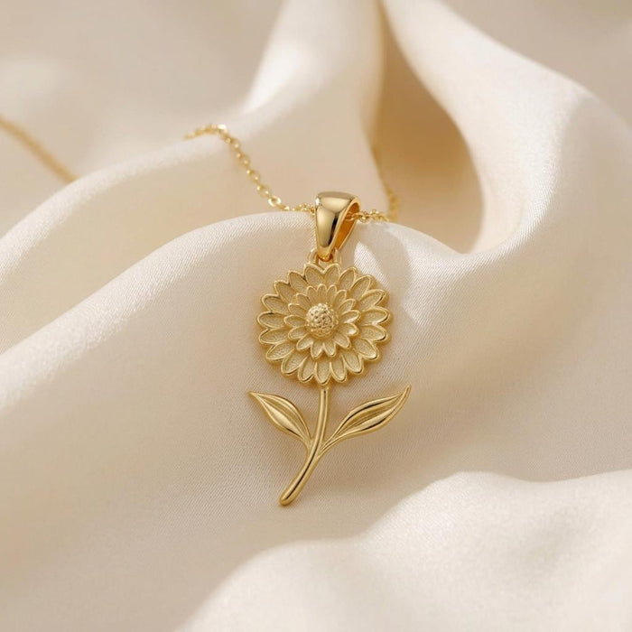 Gold Plated Silver Marigold Flower Necklace with layered petals and leaf details on ivory satin