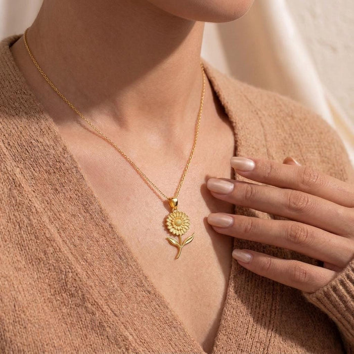 Model wearing a Gold Plated Silver Marigold Flower Necklace with a beige sweater
