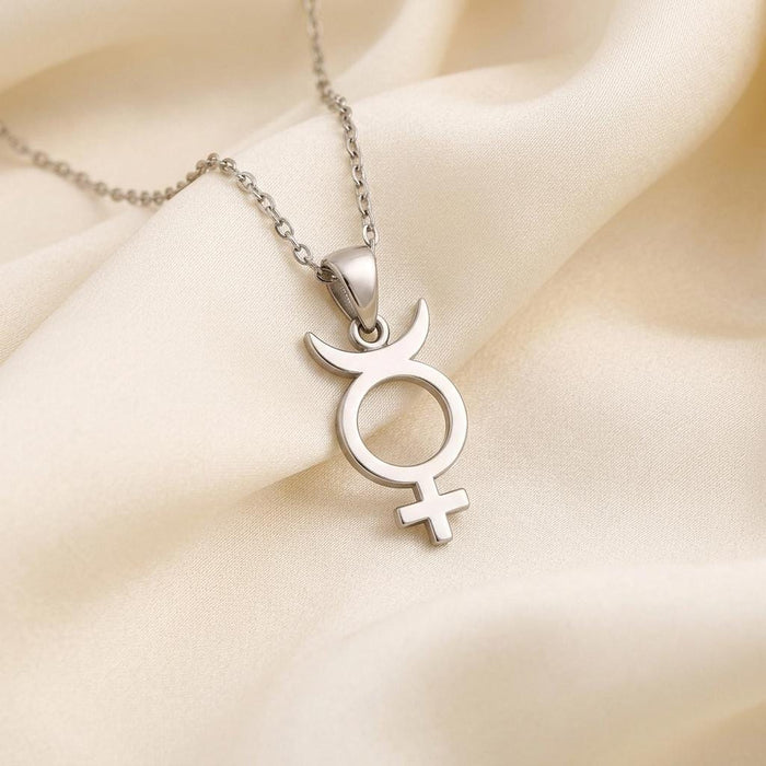 Mercury symbol pendant with crescent and cross on ivory fabric