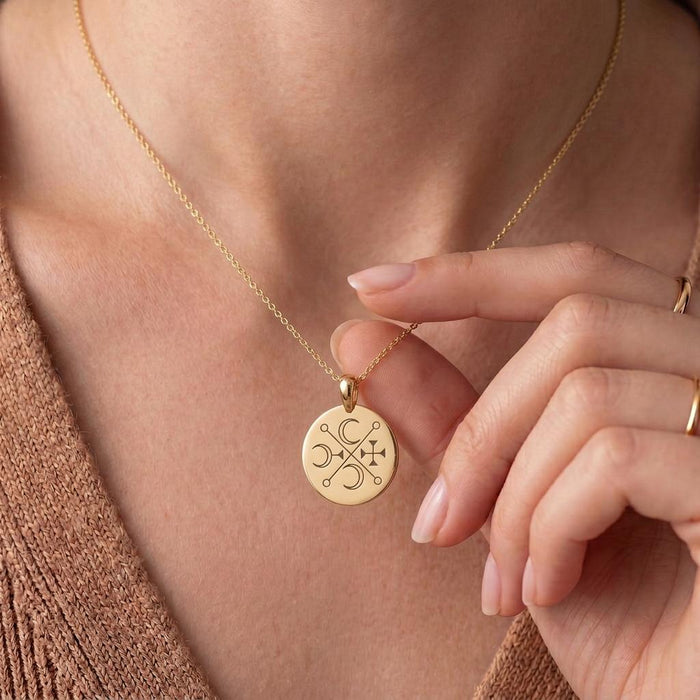 Gold Plated Silver Murmur Sigil Necklace worn at the neckline with a round engraved pendant