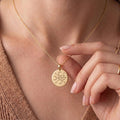 Gold Plated Silver Murmur Sigil Necklace worn at the neckline with a round engraved pendant