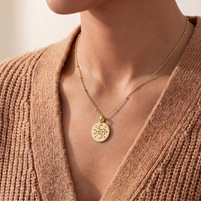Gold Plated Silver Murmur Sigil Necklace worn with a textured knit cardigan