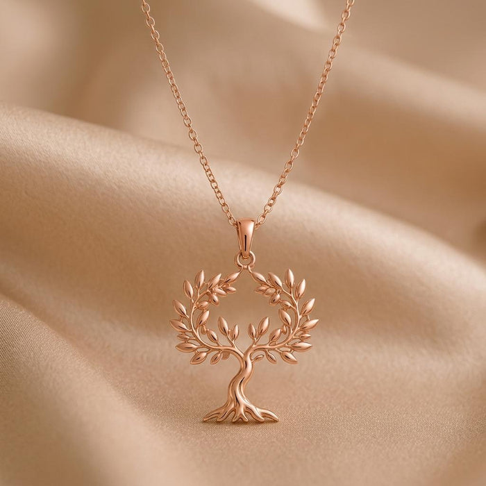 Rose Gold Plated Olive Crown Pendant Necklace with an openwork leafy tree on draped beige fabric