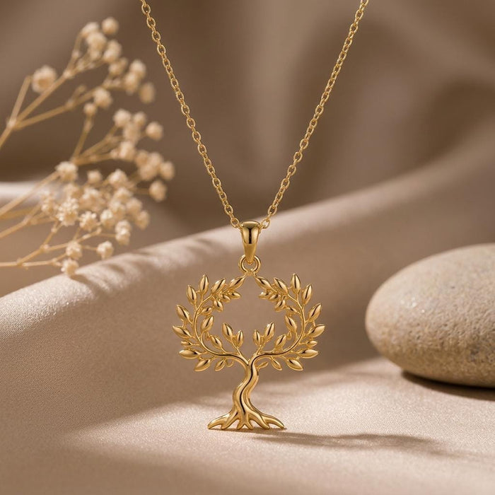 Gold Plated Silver Olive Crown Pendant Necklace beside dried flowers and a smooth stone