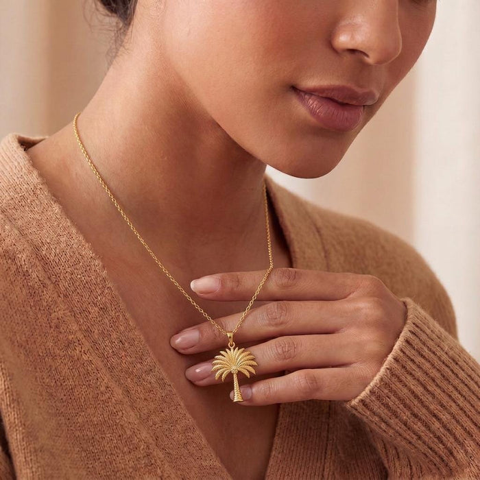 Gold Plated Silver Palm Crown Necklace worn with a neutral knit top