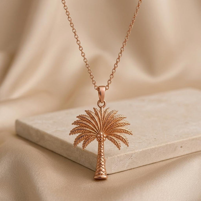 Rose Gold Plated Palm Crown Necklace displayed above a pale stone block