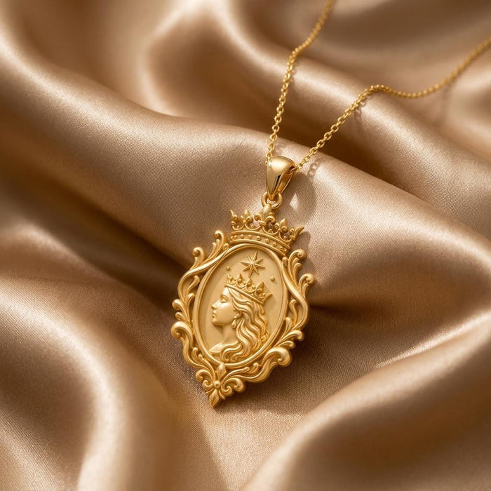Gold Plated Silver Queen Aura Pendant with crowned side-profile portrait and ornate oval frame on champagne satin