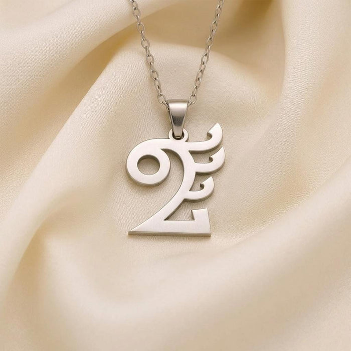 Close view of the Quetzalcóatl pendant necklace on ivory fabric