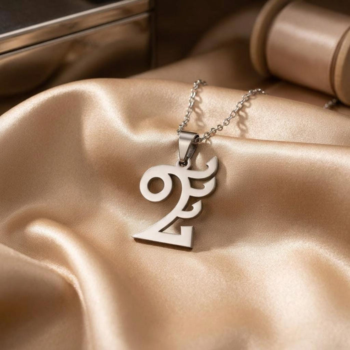 Quetzalcóatl pendant necklace arranged on champagne satin