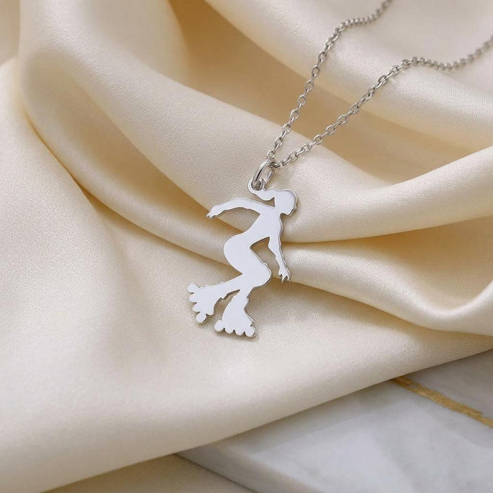 Roller Skater Necklace pendant and chain arranged on ivory satin