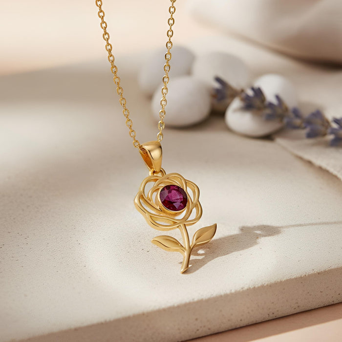 Gold Plated Silver Rose Flower Necklace with a pink round center stone on a neutral display surface