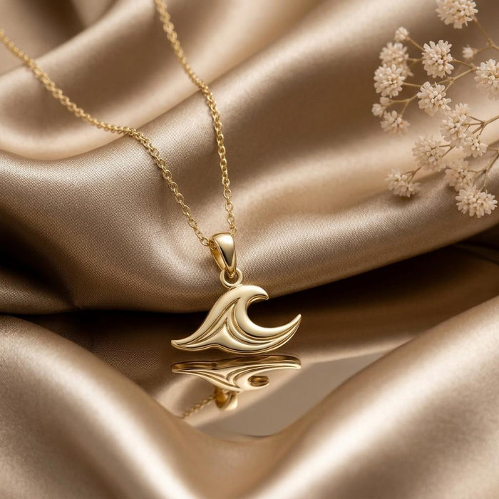 Gold Plated Silver Sea Wave Necklace with a layered wave pendant reflected on champagne satin
