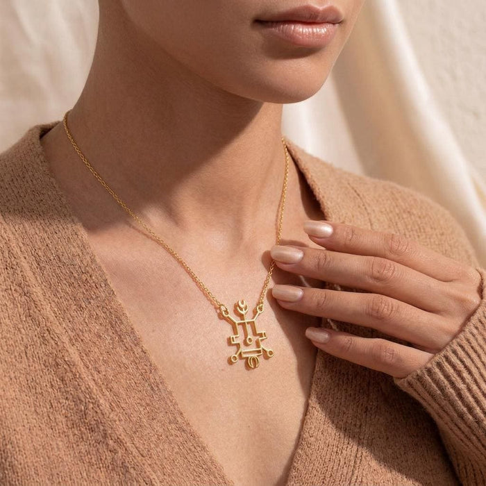 Gold Plated Silver Seal of Vassago pendant necklace held at the neckline