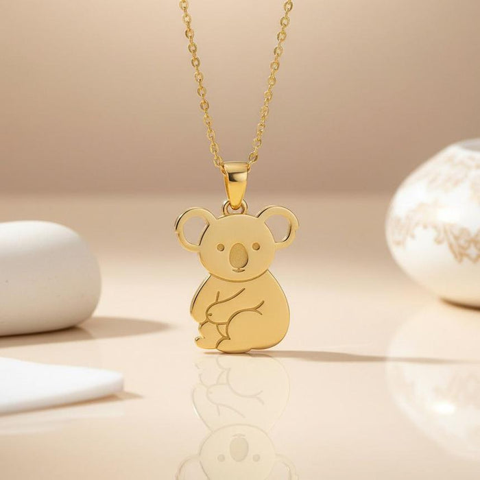 Gold Plated Silver Koala Necklace with seated koala pendant on a neutral display surface