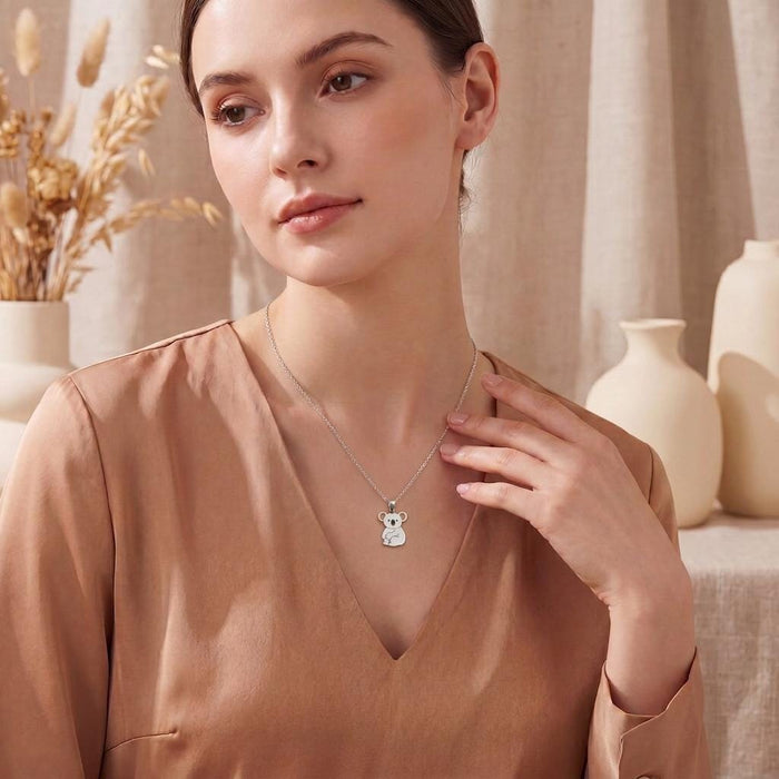 Silver Koala Necklace worn with a peach V-neck blouse