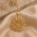 Gold Plated Silver Solstice Bloom pendant necklace with a six-petal flower, circular frame, curved rays, and leaf details on champagne satin