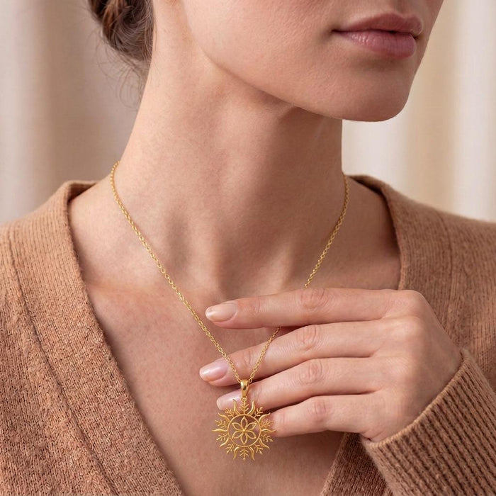 Gold Plated Silver Solstice Bloom pendant necklace worn at the collarbone with the floral sun motif visible