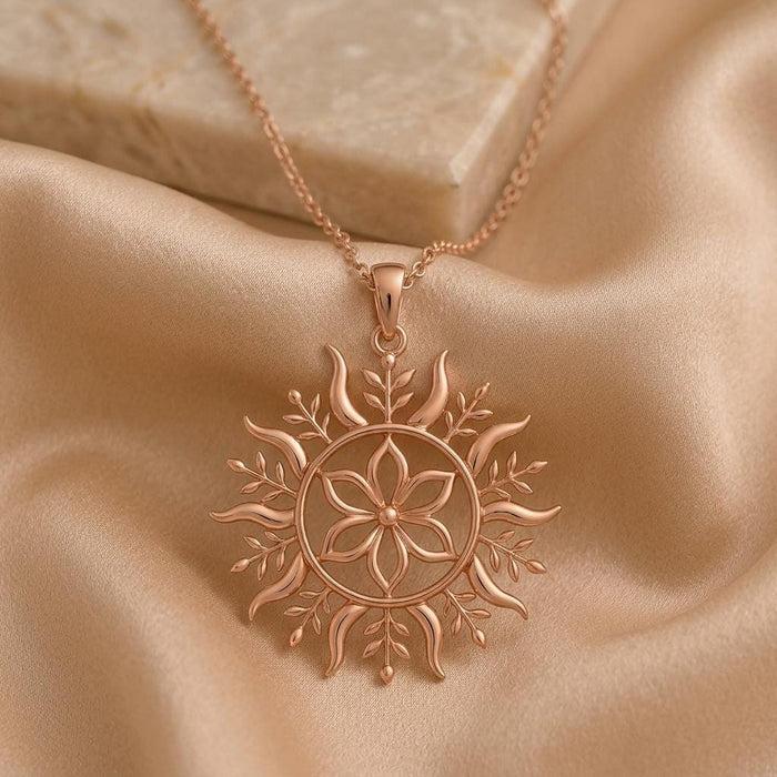 Rose Gold Plated Solstice Bloom pendant necklace on champagne satin with a six-petal flower and leaf details
