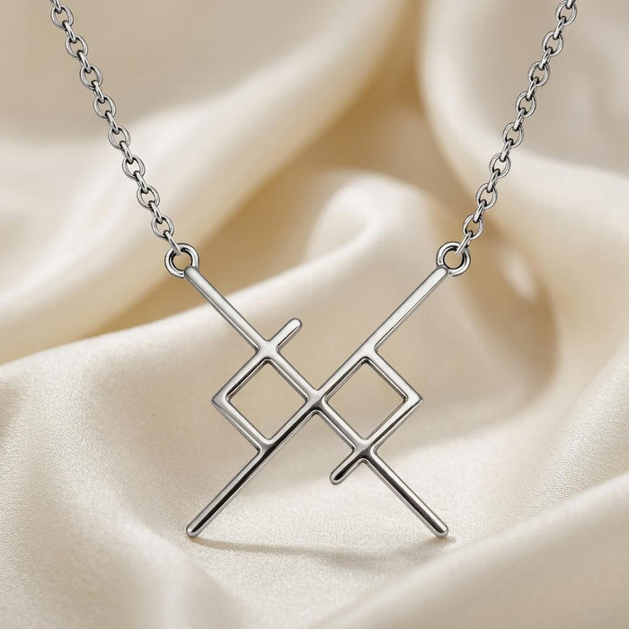 Silver Soul Bond Rune Necklace with crossed bars and two open diamond shapes on ivory satin