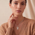 Sphinx Symbol Necklace worn with a brown V-neck knit
